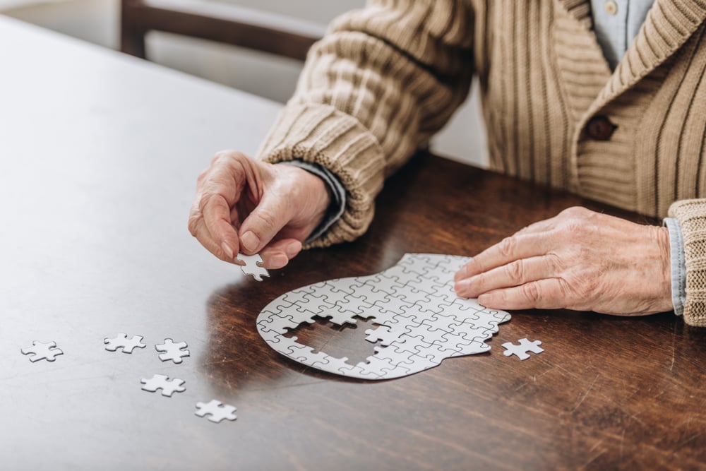  Cropped,View,Of,Senior,Man,Playing,With,Puzzles 